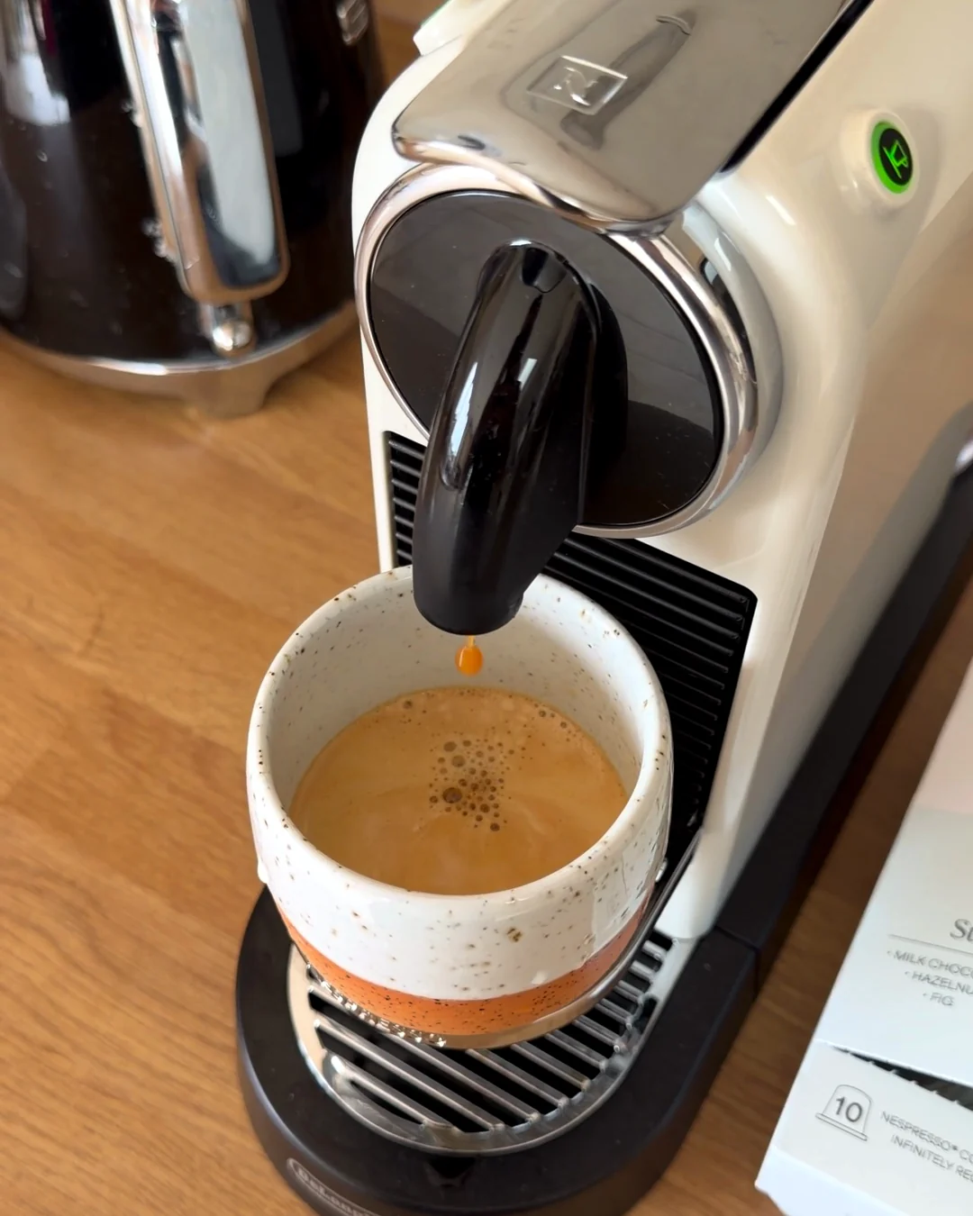 A Nespresso CitiZ brewing a shot into a speckled cup